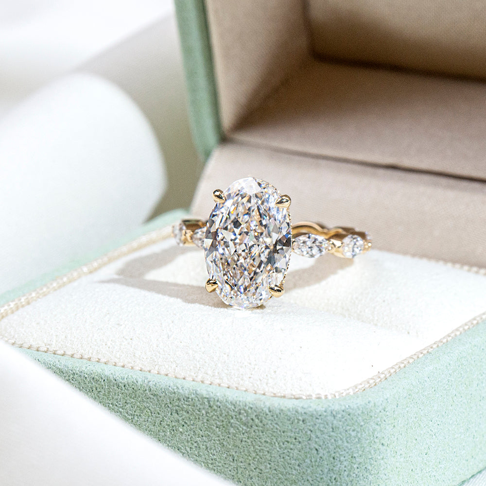 Eco-1904: Crowned Grace – Lab-Grown Oval Diamond Halo Ring with Marquise Band in 18K Yellow Gold